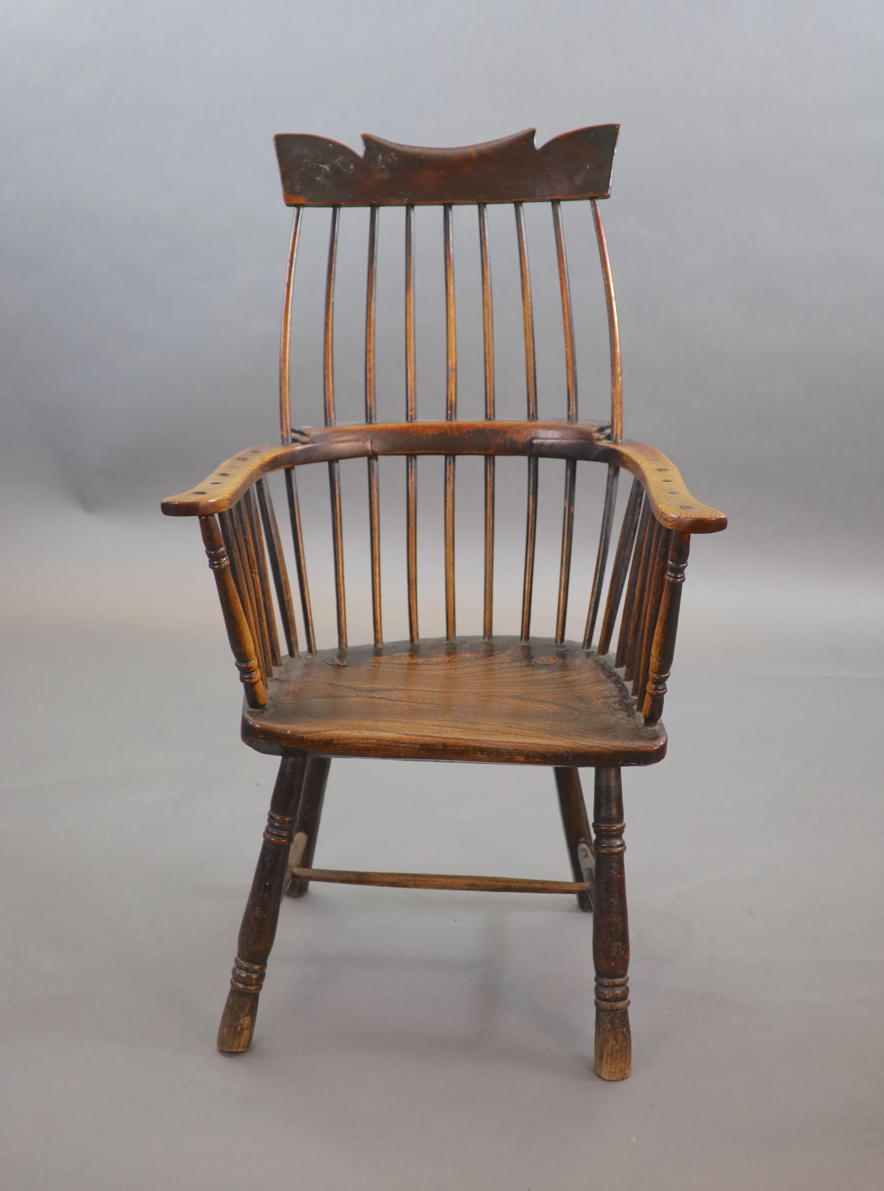 A primitive comb back Windsor armchair, possibly West Country, 67cm wide, 39cm deep, 106cm high.